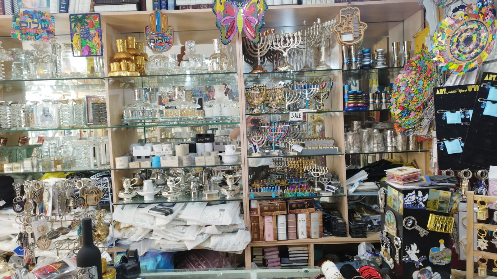 Display shelves at Ruby Judaica with menorahs, Kiddush cups, mezuzah cases and Jewish gifts